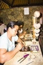 Balinese woman worker making silver jewellery in a traditional method in a Assamese jewellery manufacturing unit