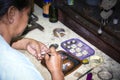 Balinese woman worker making silver jewellery in a traditional method in a Assamese jewellery manufacturing unit