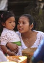 A Balinese woman and her small child in traditional clothes on Hindu Temple ceremony, Bali Island, Indonesia