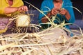Balinese women make baskets for offerings