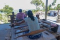 Balinese women work in an open weaving workshop on looms. Processing of hand-dyed cotton fibers. Workers work in a loom house.