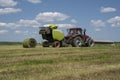 Baling hay baling, pressing hay press using a round baler. Royalty Free Stock Photo