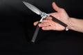 Balisong knife in the palm of your hand. Trick with a knife
