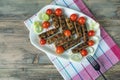 Balkan cuisine. Cevapi - grilled dish of minced meat - with vegetables. Flat lay, free space for text Royalty Free Stock Photo