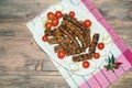 Balkan cuisine. Cevapi and kobasica - grilled dish of minced meat - on white plate. Flat lay, free space for text Royalty Free Stock Photo