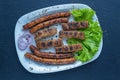 Balkan cuisine. Cevapi and kobasice - grilled dish of minced meat Royalty Free Stock Photo