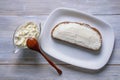 Balkan cuisine. Kaymak - local soft white cheese - on slice of bread . Copy space Royalty Free Stock Photo