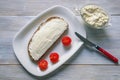 Balkan cuisine. Kaymak - soft white cheese - on slice of bread. Space for text Royalty Free Stock Photo