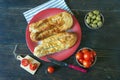 Balkan cuisine. Two bureks - popular national dish - on red plate. Flat lay