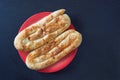 Balkan cuisine. Two bureks on red plate