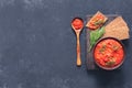 Balkan sauce ajvar in a clay bowl on a dark background. Serbian native, traditional food Royalty Free Stock Photo