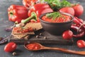 Balkan sauce ajvar in a clay bowl on a wooden table, close-up. Serbian native, traditional food Royalty Free Stock Photo