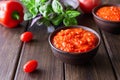 Balkan sauce ajvar and ingredients for its preparation on a wooden table. Serbian traditional food Royalty Free Stock Photo