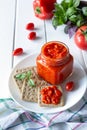 Balkan traditional dish ajvar, lutenitza, pingjur, with bread on a plate on white wooden table Royalty Free Stock Photo