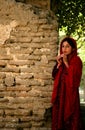 A traditional Afghan girl in a red dress in Balkh, Afghanistan