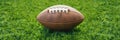 Ball for American football on fresh green field grass Royalty Free Stock Photo