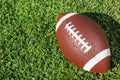 Ball for American football on fresh green field grass Royalty Free Stock Photo
