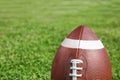 Ball for American football on fresh green field grass Royalty Free Stock Photo
