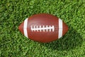 Ball for American football on fresh green field grass Royalty Free Stock Photo