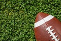 Ball for American football on fresh green field grass Royalty Free Stock Photo