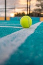 ball on the baseline of a paddle tennis court