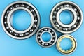 Ball bearing lying on a blue background with copy space on the sides. Flat view from above.