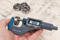 Ball bearings measurement. Micrometer screw gauge in human hand Royalty Free Stock Photo
