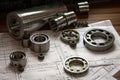 Ball bearings and rollers lie on the technical drawing of the project, Bearings milling cutters and a measuring scale on the table Royalty Free Stock Photo