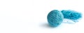 A ball of blue fine cotton yarn in the process of winding, isolated on the white background. Banner. Royalty Free Stock Photo