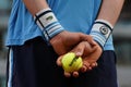 Ball boy holds Wilson Roland Garros tennis ball at Le Stade Roland Garros in Paris, France.