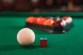 Ball and chalk on the billiard table.