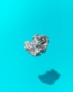 Ball of Crumpled Aluminum Foil Floating on a Blue Background Royalty Free Stock Photo