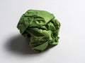 A ball of crumpled green paper on a light background Royalty Free Stock Photo