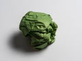 A ball of crumpled green paper on a light background Royalty Free Stock Photo