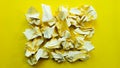 Ball crumpled paper ball isolated on a yellow background. Crumpled paper for texture. Crumpled paper after a brainstorming was