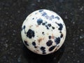 ball from Dalmatian Jasper gemstone on dark