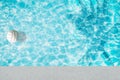 Pool float, ring floating in a refreshing blue swimming pool with palm tree leaf shadows in water Royalty Free Stock Photo