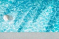 Pool float, ring floating in a refreshing blue swimming pool with palm tree leaf shadows in water Royalty Free Stock Photo