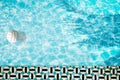 Pool float, ring floating in a refreshing blue swimming pool with palm tree leaf shadows in water Royalty Free Stock Photo