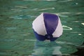 Ball floating on water surface in indoor swimming pool Royalty Free Stock Photo