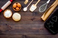 Ball of fresh raw dough near ingedients and cookware on dark wooden background top view space for text Royalty Free Stock Photo