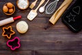 Ball of fresh raw dough near ingedients and cookware on dark wooden background top view space for text Royalty Free Stock Photo