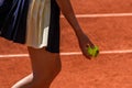 Ball girl holds Wilson Roland Garros tennis ball at Le Stade Roland Garros in Paris, France