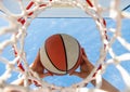 ball goes through basket. man throwing ball in hoop. hands and basketball. dunk in basket. Royalty Free Stock Photo