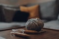 Ball of grey chunky wool yarn and large circular knitting needles on a wooden table Royalty Free Stock Photo