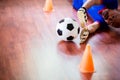 Ball in hands of futsal goalkeeper on wooden futsal floor. Indoor soccer sports hall Royalty Free Stock Photo