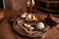 A ball of ice cream in an old ice-cream bowl on a vintage tray with white chocolate and grains of coffee,