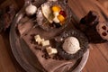 A ball of ice cream in an old ice-cream bowl on a vintage tray with white chocolate and grains of coffee