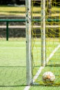 a ball inside the goal of a 7-a-side soccer field Royalty Free Stock Photo