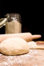 Ball of kneaded dough, rolling pin with scattered flour
